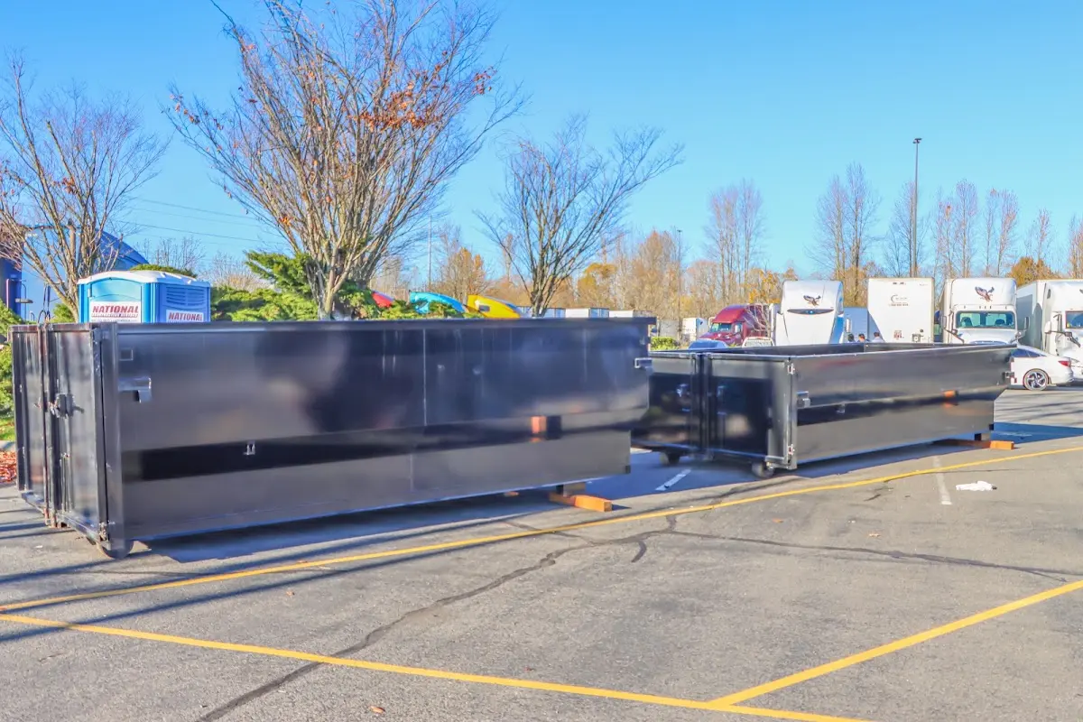 Professional dumpster rental service with roll-off container on residential driveway in Bryant